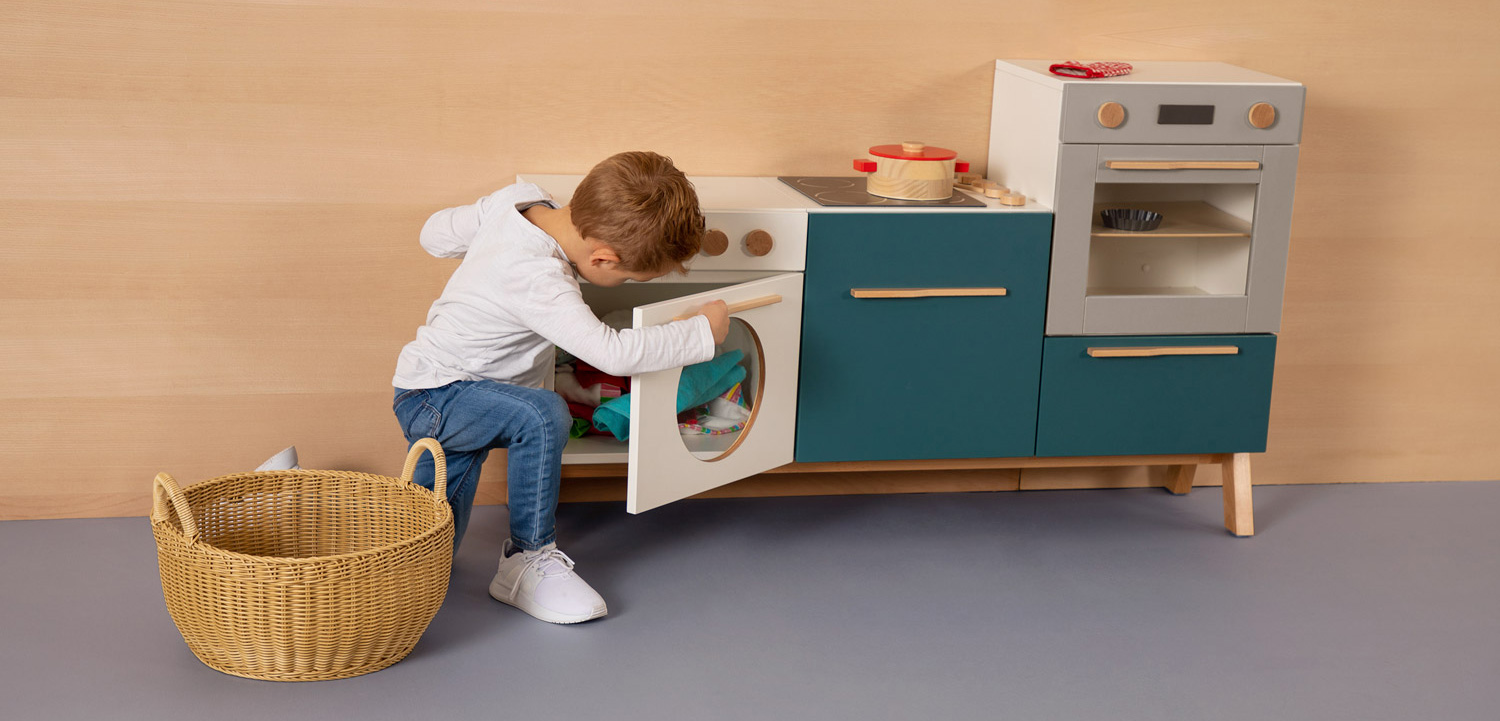 Junge spielt Wäsche waschen mit der kowidu Küche
